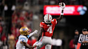 Ohio State Buckeyes wide receiver Jeremiah Smith (4) makes a one-handed catch in front of UCLA Bruins defensive back Andre Jordan Jr. (2) during the NCAA football game at Ohio Stadium in Columbus on Nov. 15, 2025.