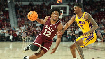 Mar 1, 2025; Starkville, Mississippi, USA; Mississippi State Bulldogs guard Josh Hubbard (12) drives to the basket against LSU Tigers guard Cam Carter (5) during the second half at Humphrey Coliseum. Mandatory Credit: Wesley Hale-Imagn Images
