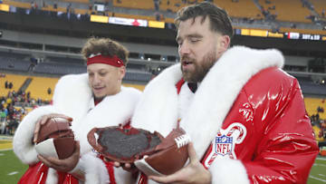 Dec 25, 2024; Pittsburgh, Pennsylvania, USA;  Kansas City Chiefs quarterback Patrick Mahomes (left) and tight end Travis Kelce (right) open their Netflix Christmas GameDay cake after the Chiefs defeated the Pittsburgh Steelers at Acrisure Stadium. Mandatory Credit: Charles LeClaire-Imagn Images