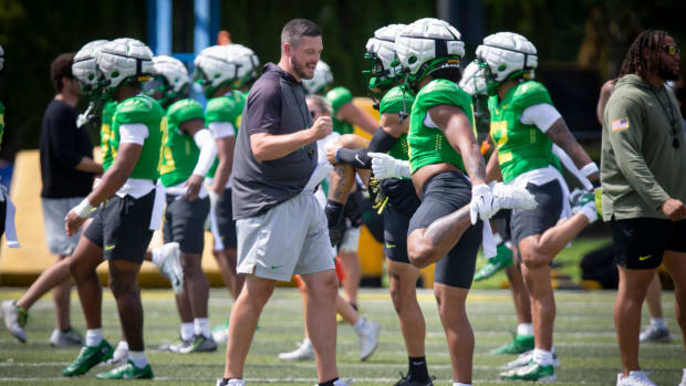 Oregon head coach Dan Lanning walks the field during the Ducks’ fall camp Wednesday, 