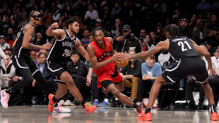 Apr 10, 2024; Brooklyn, New York, USA; Toronto Raptors guard Immanuel Quickley (5) drives to the basket against Brooklyn Nets center Nic Claxton (33) and guard Cam Thomas (24) and forward Noah Clowney (21) during the fourth quarter at Barclays Center. Mandatory Credit: Brad Penner-USA TODAY Sports