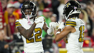 Oct 7, 2024; Kansas City, Missouri, USA; New Orleans Saints wide receiver Rashid Shaheed (22) celebrates with wide receiver Chris Olave (12) after scoring a touchdown during the first half against the Kansas City Chiefs at GEHA Field at Arrowhead Stadium.