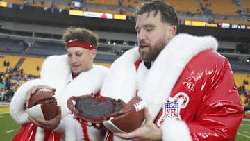 Dec 25, 2024; Pittsburgh, Pennsylvania, USA;  Kansas City Chiefs quarterback Patrick Mahomes (left) and tight end Travis Kelce (right) open their Netflix Christmas GameDay cake after the Chiefs defeated the Pittsburgh Steelers at Acrisure Stadium. Mandatory Credit: Charles LeClaire-Imagn Images