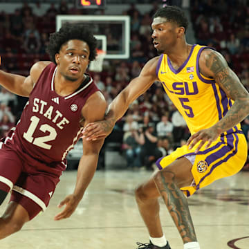 Mar 1, 2025; Starkville, Mississippi, USA; Mississippi State Bulldogs guard Josh Hubbard (12) drives to the basket against LSU Tigers guard Cam Carter (5) during the second half at Humphrey Coliseum. Mandatory Credit: Wesley Hale-Imagn Images