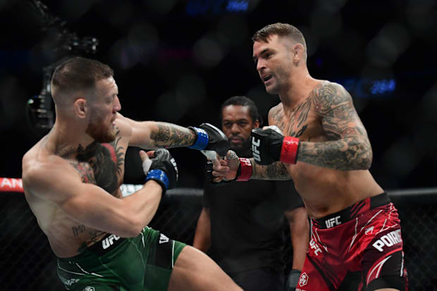 Dustin Poirier moves in for a hit against Conor McGregor during UFC 264 at T-Mobile Arena.