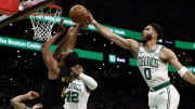 Boston Celtics star Jayson Tatum blocks Evan Mobley of the Cleveland Cavaliers.