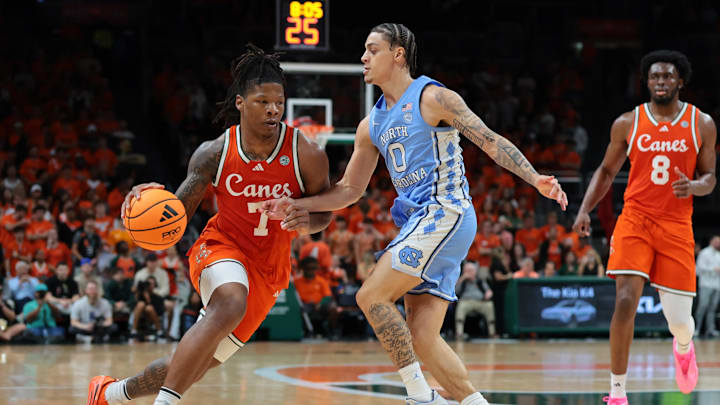 Feb 10, 2026; Coral Gables, Florida, USA; Miami Hurricanes forward Shelton Henderson (7) drives to the basket against North Carolina Tar Heels guard Kyan Evans (0) during the first half at Watsco Center. Mandatory Credit: Sam Navarro-Imagn Images