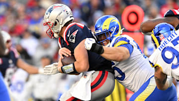 Nov 17, 2024; Foxborough, Massachusetts, USA; Los Angeles Rams defensive tackle Braden Fiske (55) tackles New England Patriots quarterback Drake Maye (10) during the second half at Gillette Stadium. Mandatory Credit: Brian Fluharty-Imagn Images
