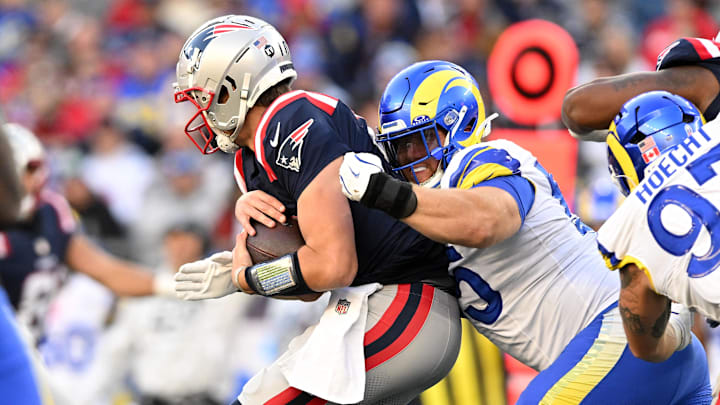 Nov 17, 2024; Foxborough, Massachusetts, USA; Los Angeles Rams defensive tackle Braden Fiske (55) tackles New England Patriots quarterback Drake Maye (10) during the second half at Gillette Stadium. Mandatory Credit: Brian Fluharty-Imagn Images