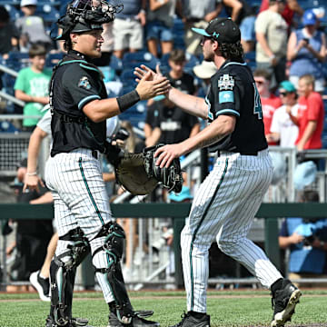 Jun 18, 2025; Omaha, Neb, USA;  Coastal Carolina Chanticleers pitcher Dominick Carbone (40) and catcher Caden Bodine (17) meet after the win against the Coastal Carolina Chanticleers at Charles Schwab Field. Mandatory Credit: Steven Branscombe-Imagn Images