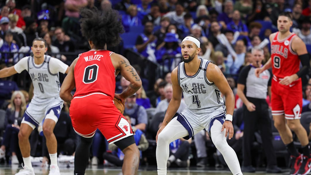 Nov 27, 2024; Orlando, Florida, USA; Orlando Magic guard Jalen Suggs (4) defends Chicago Bulls guard Coby White (0) during the second quarter at Kia Center. Mandatory Credit: Mike Watters-Imagn Images