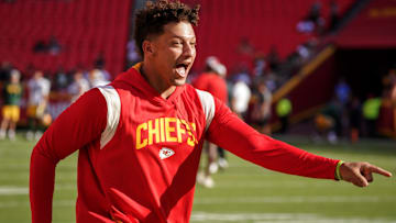 Aug 25, 2022; Kansas City, Missouri, USA; Kansas City Chiefs quarterback Patrick Mahomes (15) laughs after catching a pass over tight end Travis Kelce (not pictured) during warm ups before a preseason game against the Green Bay Packers at GEHA Field at Arrowhead Stadium. Mandatory Credit: Denny Medley-Imagn Images