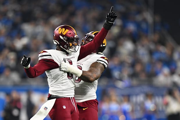 Washington Commanders linebacker Dante Fowler Jr. celebrates a recovered fumble with defensive tackle Jonathan Allen.