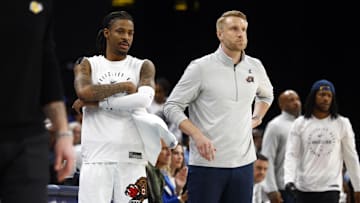 Mar 29, 2025; Memphis, Tennessee, USA; Memphis Grizzlies guard Ja Morant (left) and interim head coach Tuomas Iisalo (right) look on during the fourth quarter against the Los Angeles Lakers at FedExForum. Mandatory Credit: Petre Thomas-Imagn Images
