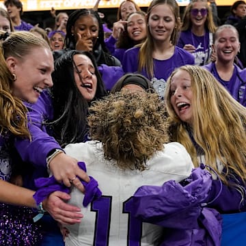 Brownsburg Bulldogs Drew Bostic (11) hugs fans Friday, Nov. 29, 2024, during the IHSAA Class 6A State Finals game at Lucas Oil Stadium in Indianapolis. The Brownsburg Bulldogs defeated the Westfield Shamrocks, 22-17.