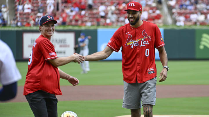 Aug 18, 2024; St. Louis, Missouri, USA; Florida Panthers right wing Matthew Tkachuk and Boston Celtics forward Jayson Tatum greet each other after throwing out a ceremonial first pitch prior to a game between the St. Louis Cardinals and the Los Angeles Dodgers  Busch Stadium. Mandatory Credit: Joe Puetz-USA TODAY Sports