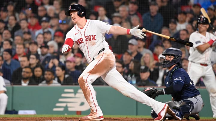 May 16, 2024; Boston, Massachusetts, USA;  Boston Red Sox designated hitter Garrett Cooper (28) hits an RBI double against the Tampa Bay Rays  during the fifth inning at Fenway Park