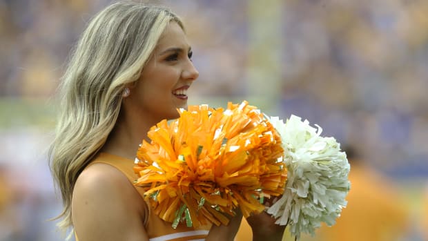 A cheerleader for the Tennessee Volunteers team during a college football game in the SEC.