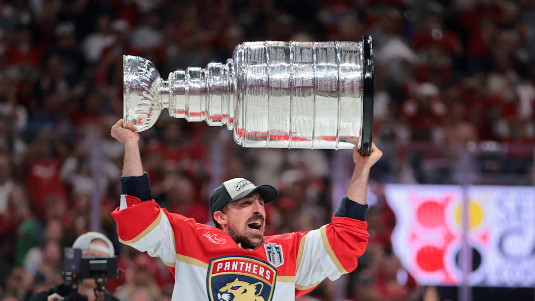 Jun 17, 2025; Sunrise, Florida, USA; Florida Panthers center Brad Marchand (63) hoists the Stanley Cup after winning game six of the 2025 Stanley Cup Final against the Edmonton Oilers at Amerant Bank Arena. 
