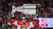 Jun 17, 2025; Sunrise, Florida, USA; Florida Panthers center Brad Marchand (63) hoists the Stanley Cup after winning game six of the 2025 Stanley Cup Final against the Edmonton Oilers at Amerant Bank Arena. 