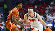 Jan 29, 2025; Oxford, Mississippi, USA; Mississippi Rebels guard Sean Pedulla (3) drives to the basket as Texas Longhorns guard Julian Larry (1) defends during the second half at The Sandy and John Black Pavilion at Ole Miss. Mandatory Credit: Petre Thomas-Imagn Images