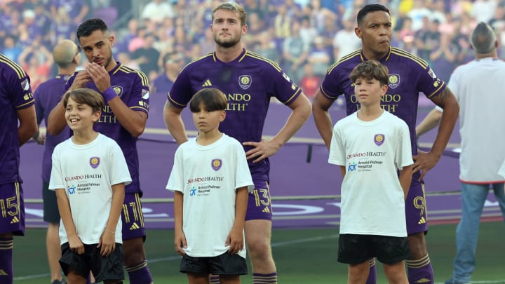 May 15, 2024; Orlando, Florida, USA;  Inter Miami CF midfielder Facundo Farias (11),  forward Duncan McGuire (13) and forward Luis Muriel (9) stand as they escort kids out for the National Anthem between the Inter Miami and the Orlando City at Inter&Co Stadium. Mandatory Credit: Kim Klement Neitzel-USA TODAY Sports