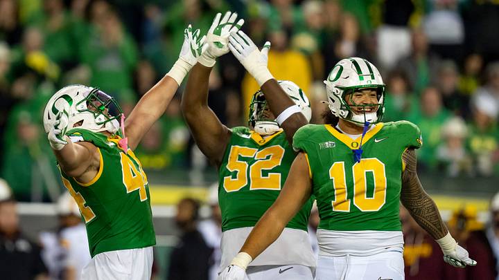Oregon outside linebacker Teitum Tuioti, left, defensive lineman A'Mauri Washington and outside linebacker Matayo Uiagalelei celebrate a sack by Tuioti as the Oregon Ducks host the Minnesota Golden Gophers on Nov. 14, 2025, at Autzen Stadium in Eugene, Oregon.