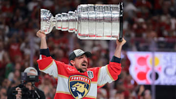 Florida Panthers center Brad Marchand hoists the Stanley Cup after winning game six of the 2025 Stanley Cup Final.