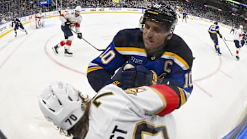 Feb 6, 2025; St. Louis, Missouri, USA;  St. Louis Blues center Brayden Schenn (10) checks Florida Panthers center Jesper Boqvist (70) during the second period at Enterprise Center. Mandatory Credit: Jeff Curry-Imagn Images