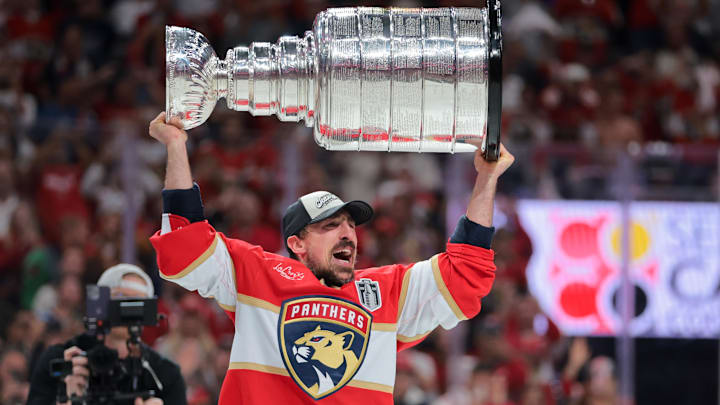 Jun 17, 2025; Sunrise, Florida, USA; Florida Panthers center Brad Marchand (63) hoists the Stanley Cup after winning game six of the 2025 Stanley Cup Final against the Edmonton Oilers at Amerant Bank Arena. Mandatory Credit: Sam Navarro-Imagn Images