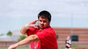 Jackson Cantwell spins around as he practices throwing a shotput during track and field practice at Nixa High School on Wednesday, April 24, 2024.