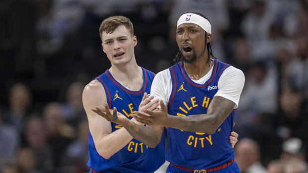 May 10, 2024; Minneapolis, Minnesota, USA; Denver Nuggets guard Christian Braun (0) and Denver Nuggets guard Kentavious Caldwell-Pope (5) react to a call on the court against the Minnesota Timberwolves in the first half during game three of the second round for the 2024 NBA playoffs at Target Center. Mandatory Credit: Jesse Johnson-USA TODAY Sports