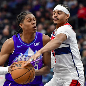 Mar 19, 2025; Salt Lake City, Utah, USA;  Washington Wizards guard Jordan Poole (13) makes steal attempt against Utah Jazz forward Cody Williams (5) during the second half at the Delta Center. Mandatory Credit: Peter Creveling-Imagn Images