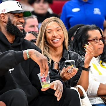 Mar 28, 2023; Houston, TX, USA; Los Angeles Laker LeBron James and his wife Savannah James sit court side at the McDonald's All American game during the first half at Toyota Center.