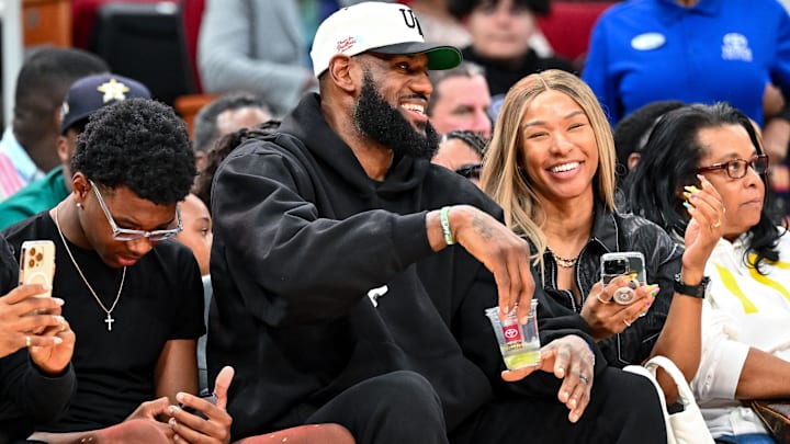 Mar 28, 2023; Houston, TX, USA; Los Angeles Laker LeBron James and his wife Savannah James sit court side at the McDonald's All American game during the first half at Toyota Center.