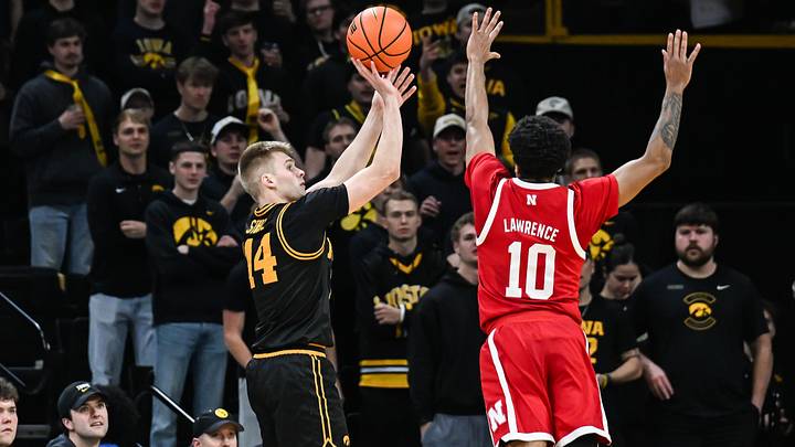 Feb 17, 2026; Iowa City, Iowa, USA; Iowa Hawkeyes guard Bennett Stirtz (14) shoots the ball over Nebraska Cornhuskers guard Jamarques Lawrence (10) during the first half at Carver-Hawkeye Arena. Mandatory Credit: Jeffrey Becker-Imagn Images