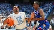 Nov 7, 2025; Chapel Hill, North Carolina, USA;  North Carolina Tar Heels forward Jarin Stevenson (15) with the balll as Kansas Jayhawks guard Elmarko Jackson (13) defends in the second half at Dean E. Smith Center. Mandatory Credit: Bob Donnan-Imagn Images