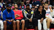 Oct 4, 2021; Los Angeles, California, USA; Los Angeles Clippers players Marcus Morris, Nicolas Batum, Serge Ibaka and Kawhi Leonard watch game action against the Denver Nuggets during the first half at Staples Center. Mandatory Credit: Gary A. Vasquez-Imagn Images