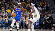 Oct 23, 2025; Indianapolis, Indiana, USA;  Oklahoma City Thunder guard Luguentz Dort (5) dribbles the ball while Indiana Pacers forward Jarace Walker (5) defends in the second half at Gainbridge Fieldhouse. Mandatory Credit: Trevor Ruszkowski-Imagn Images