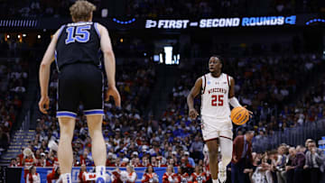 Mar 22, 2025; Denver, CO, USA; Wisconsin Badgers guard John Blackwell (25) dribbles the ball against Brigham Young Cougars forward Richie Saunders (15) during the first half in the second round of the NCAA Tournament  at Ball Arena. Mandatory Credit: Isaiah J. Downing-Imagn Images