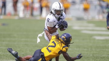 Aug 31, 2024; Morgantown, West Virginia, USA; Penn State Nittany Lions wide receiver Omari Evans (5) make a catch over West Virginia Mountaineers safety Aubrey Burks (2) during the second quarter at Mountaineer Field at Milan Puskar Stadium. 