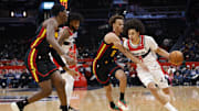 Dec 6, 2025; Washington, District of Columbia, USA; Washington Wizards forward Kyshawn George (18) drives to the basket as Atlanta Hawks guard Dyson Daniels (5) defends in the first half at Capital One Arena. Mandatory Credit: Geoff Burke-Imagn Images