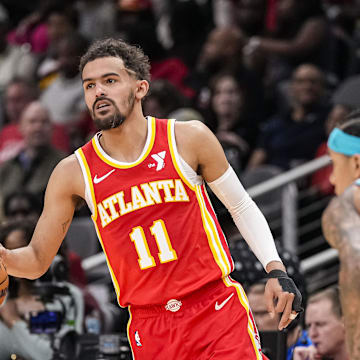 Apr 10, 2024; Atlanta, Georgia, USA; Atlanta Hawks guard Trae Young (11) controls the ball against the Charlotte Hornets during the first half at State Farm Arena. Mandatory Credit: Dale Zanine-Imagn Images