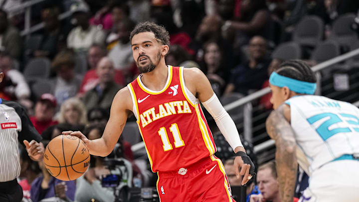 Apr 10, 2024; Atlanta, Georgia, USA; Atlanta Hawks guard Trae Young (11) controls the ball against the Charlotte Hornets during the first half at State Farm Arena. Mandatory Credit: Dale Zanine-Imagn Images