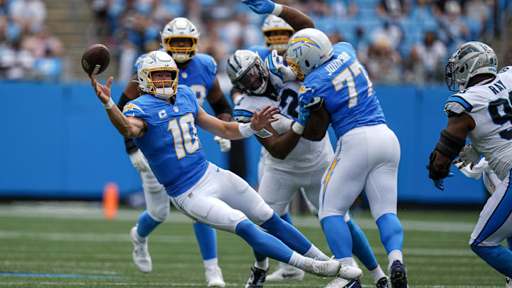 Sep 15, 2024; Charlotte, North Carolina, USA; Los Angeles Chargers quarterback Justin Herbert (10) throws a pass under pressure during the first quarter against the Carolina Panthers at Bank of America Stadium.