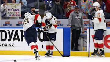 Apr 30, 2025; Tampa, Florida, USA; Florida Panthers left wing Matthew Tkachuk (19) passes a rat onto center Brad Marchand (63) after they beat the Tampa Bay Lightning during the third period of game five of the first round of the 2025 Stanley Cup Playoffs at Amalie Arena. Mandatory Credit: Kim Klement Neitzel-Imagn Images