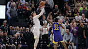 Feb 15, 2024; Salt Lake City, Utah, USA: Utah Jazz forward Lauri Markkanen (23) shoots the ball over Golden State Warriors forward Andrew Wiggins (22) during the second half at Delta Center. Mandatory Credit: Chris Nicoll-Imagn Images