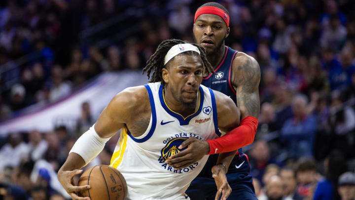 Feb 7, 2024; Philadelphia, Pennsylvania, USA; Golden State Warriors forward Kevon Looney (5) drives past Philadelphia 76ers forward Paul Reed (44) during the fourth quarter at Wells Fargo Center. Mandatory Credit: Bill Streicher-USA TODAY Sports