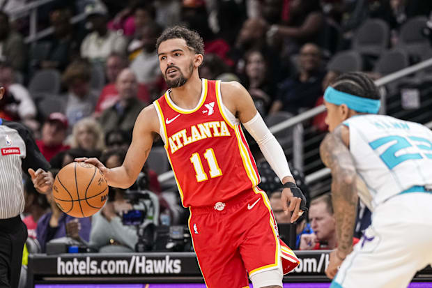 Atlanta Hawks guard Trae Young (11) controls the ball against the Charlotte Hornets during the 2023-24 season.