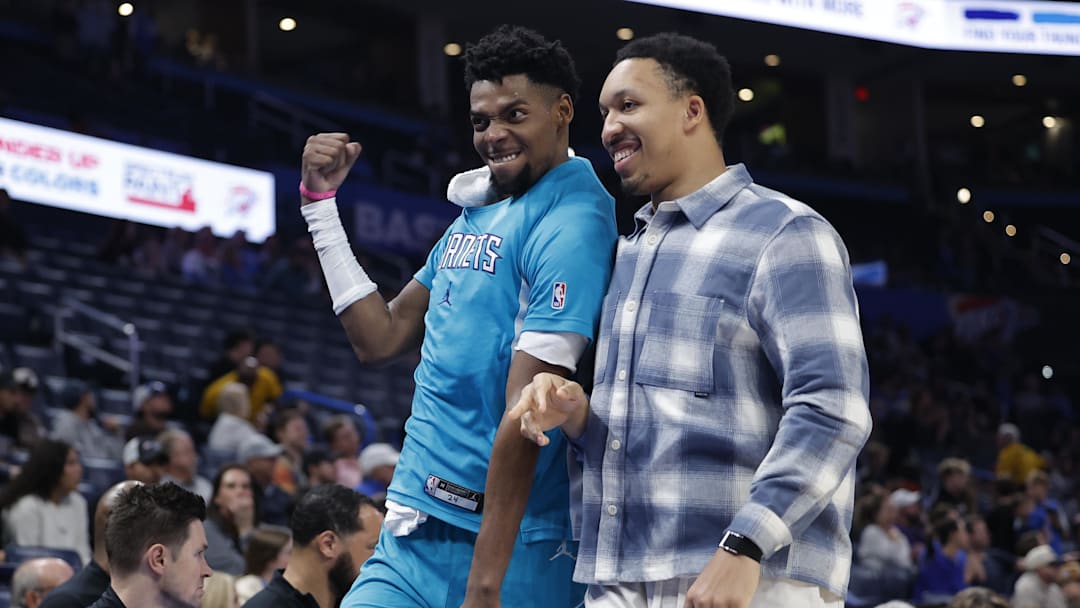 Jan 5, 2026; Oklahoma City, Oklahoma, USA; Charlotte Hornets forward Brandon Miller (24) and Charlotte Hornets forward Grant Williams (2) celebrate in the final seconds of a game against the Oklahoma City Thunder at Paycom Center. Mandatory Credit: Alonzo Adams-Imagn Images